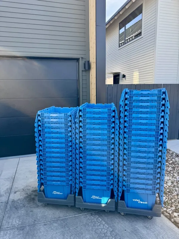 SwiftCrates plastic moving crates delivered and stacked outside an Austin home