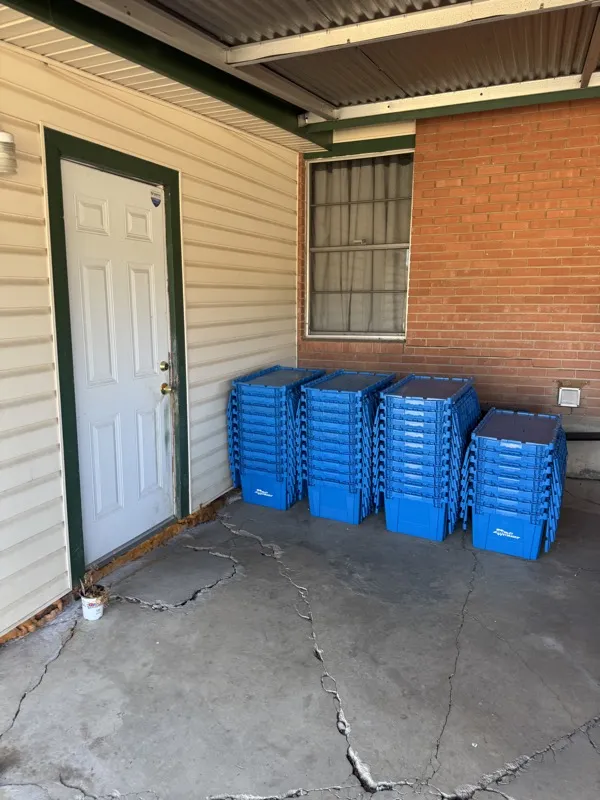 SwiftCrates plastic moving crates staged neatly at an Austin porch